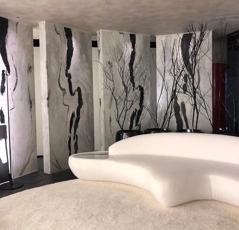 Sala com painéis curvos de rocha e sofá orgânico